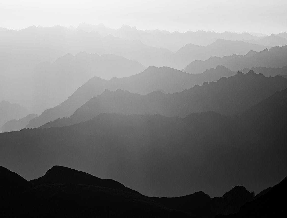 Layered mountain ridgelines in morning haze